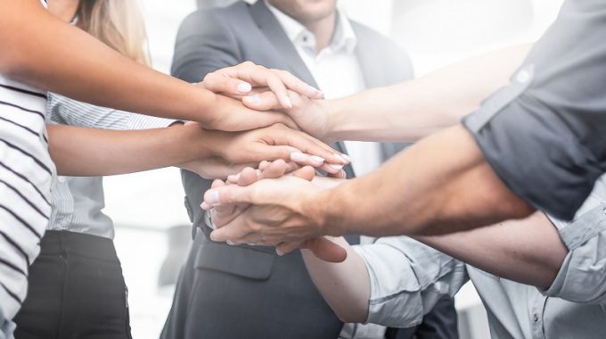 Hands Stacked Together Symbolizing A Winning Event Team Culture