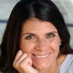 Mia Hamm smiling at camera with hand on chin